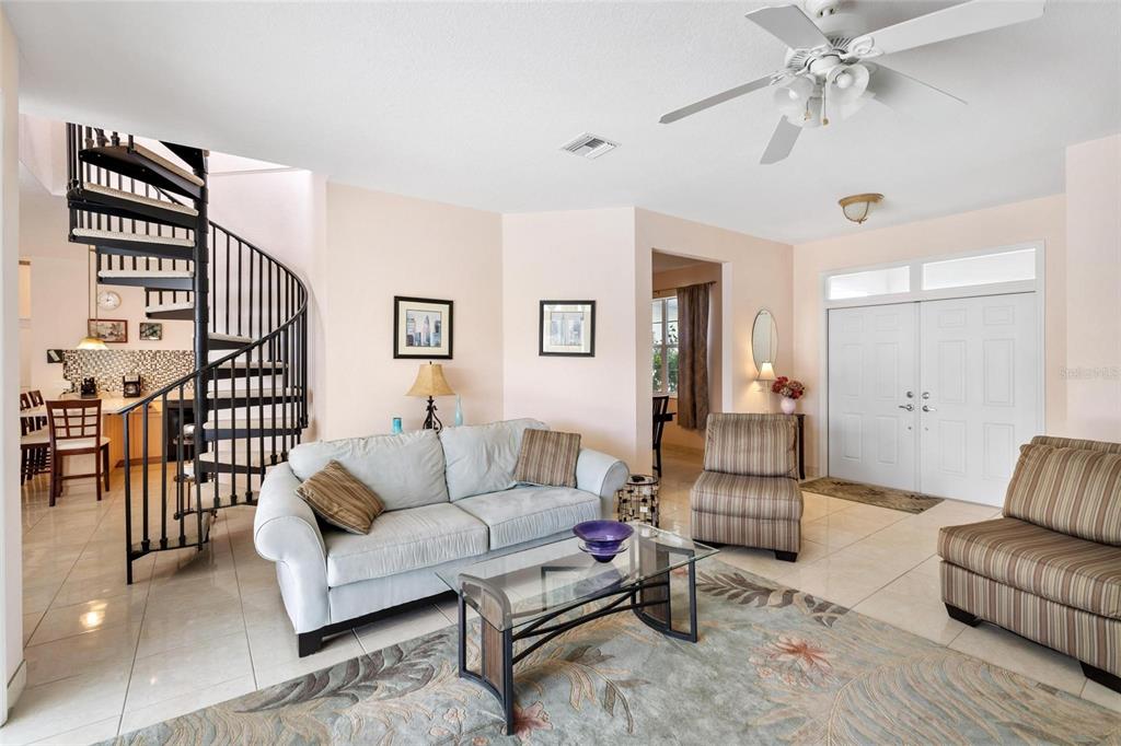 8069 Southwest Aviary Road Arcadia, FL 34269 - Photo 9 of 60 a living room with furniture or couch and a chandelier