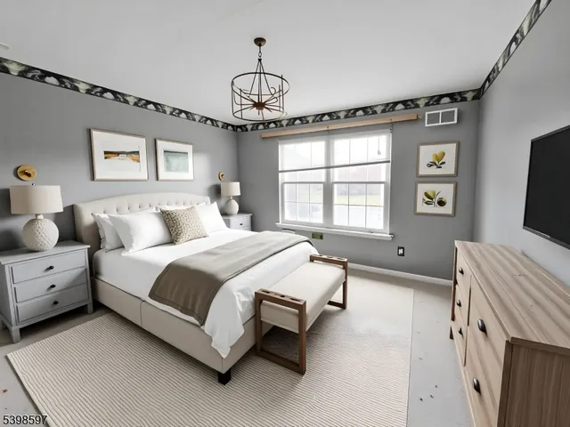 a spacious bedroom with a bed and a flat tv screen on dresser