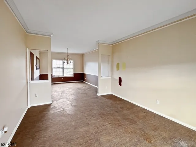 a view of a big room with closet and windows