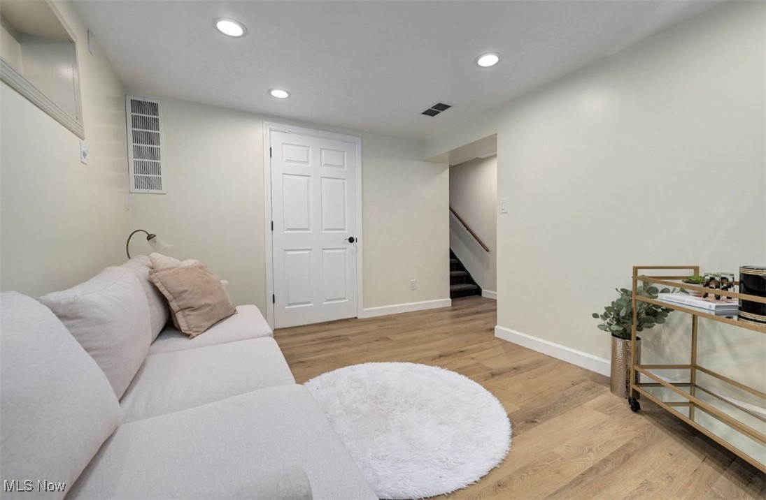 16501 Munn Road Cleveland, OH 44111 - Photo 32 of 42 Living room featuring recessed lighting, wood finished floors, and stairway