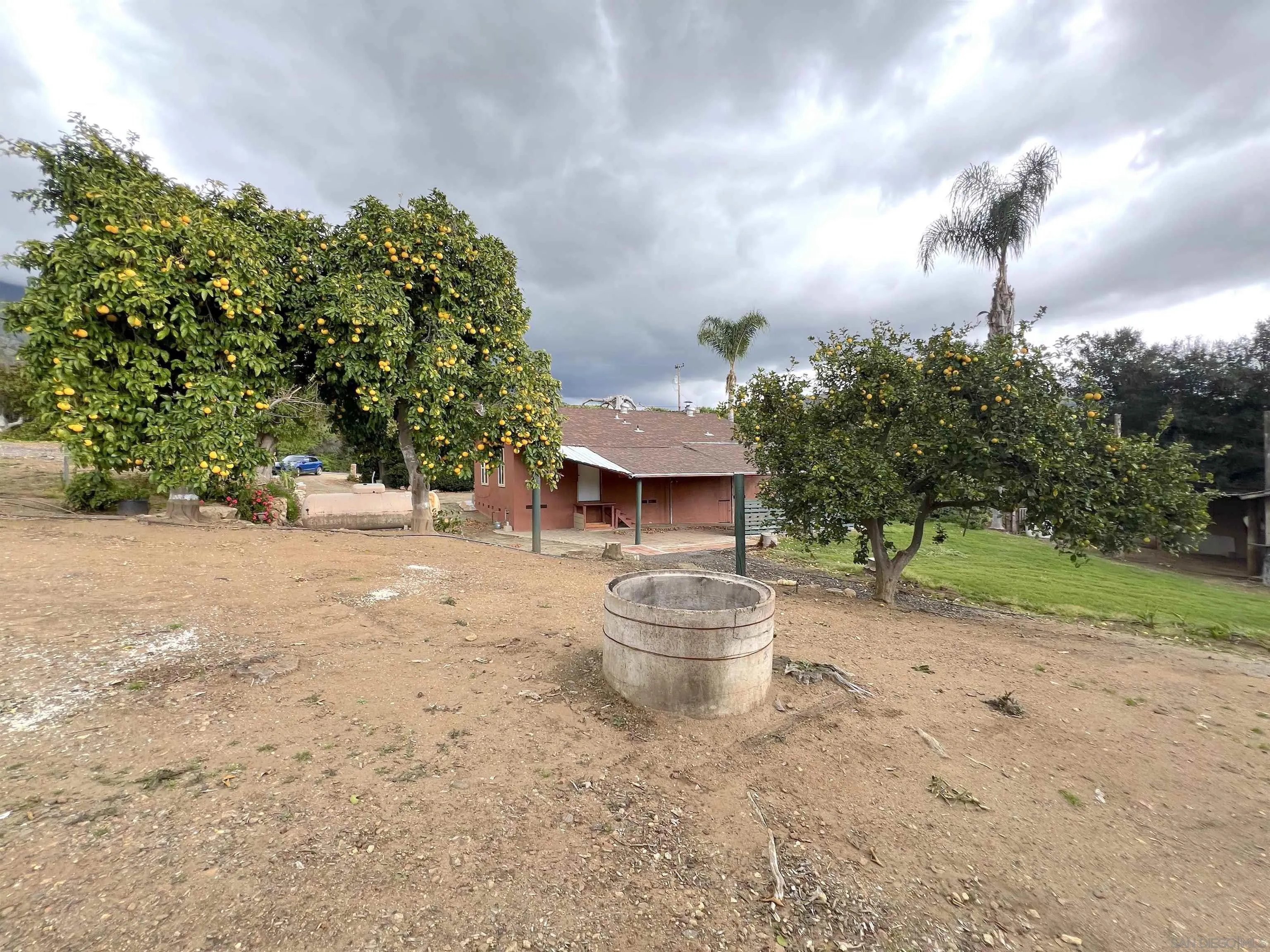 32500 Rincon Ranch Road Pauma Valley, CA 92061 - Photo 17 of 19 a backyard of a house with table and chairs