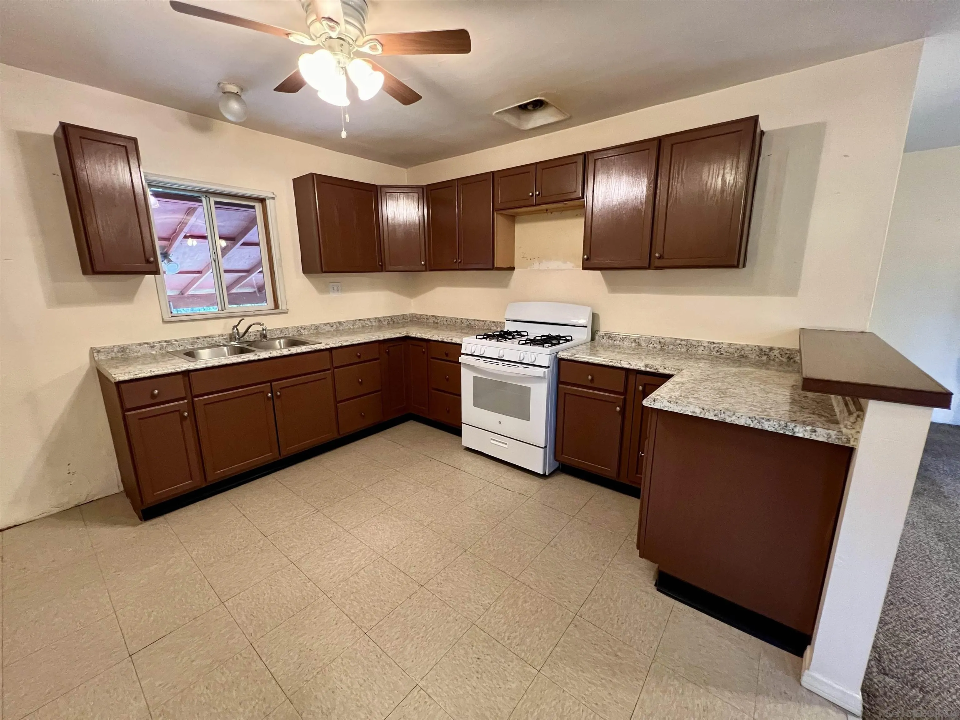 32500 Rincon Ranch Road Pauma Valley, CA 92061 - Photo 2 of 19 a kitchen with stainless steel appliances granite countertop refrigerator a stove and a sink