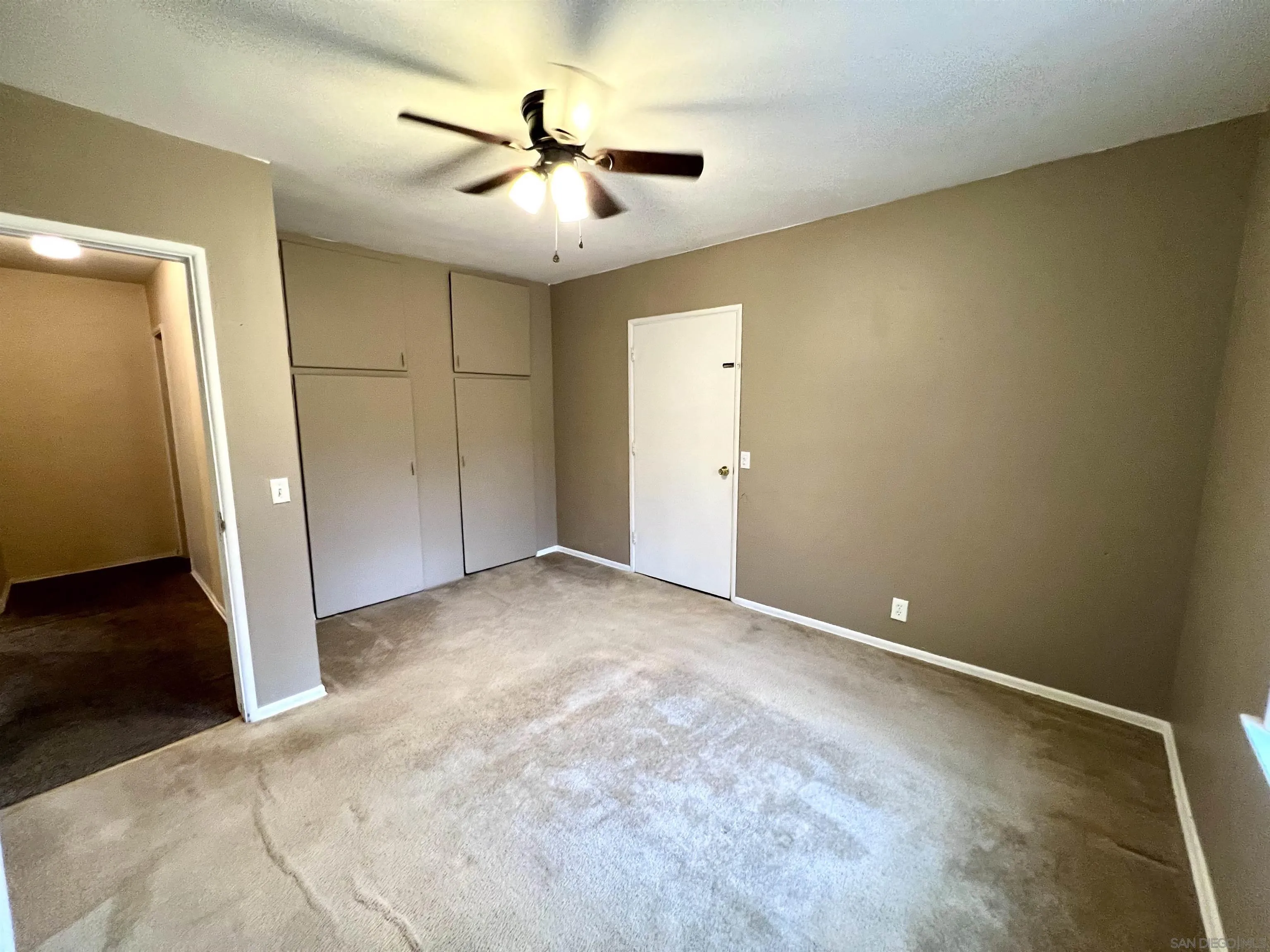 32500 Rincon Ranch Road Pauma Valley, CA 92061 - Photo 8 of 19 an empty room with a ceiling fan and hardwood floor
