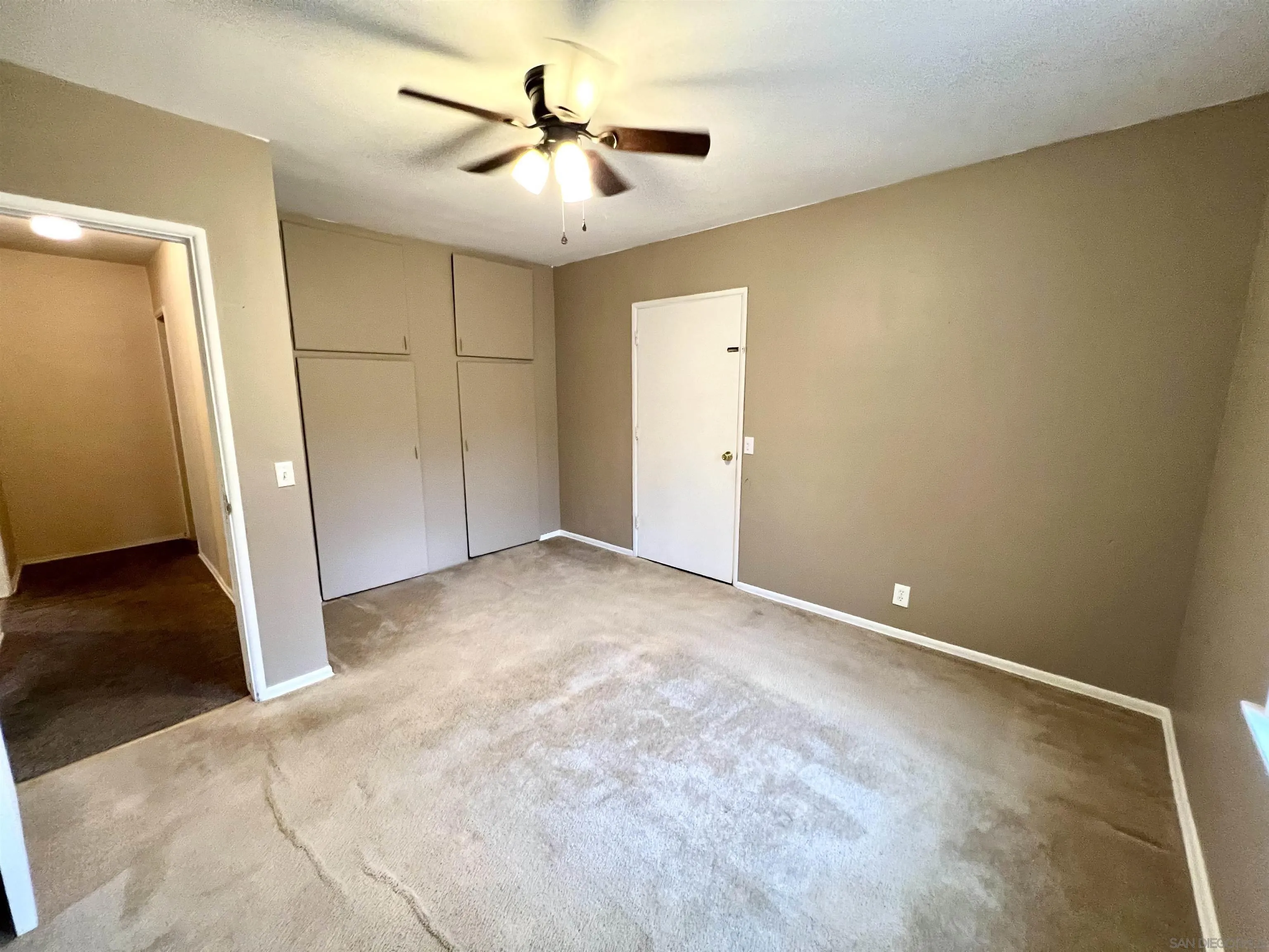 32500 Rincon Ranch Road Pauma Valley, CA 92061 - Photo 9 of 19 an empty room with a ceiling fan and hardwood floor