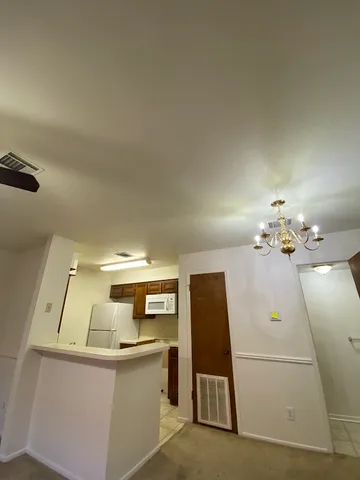 a view of a kitchen with a sink and a fireplace