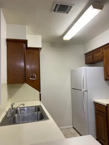 a room with refrigerator and mirror