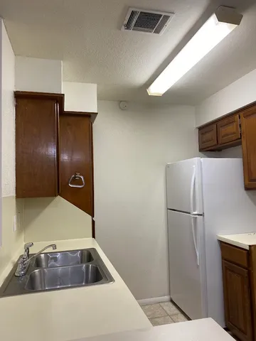 a kitchen with a refrigerator and microwave