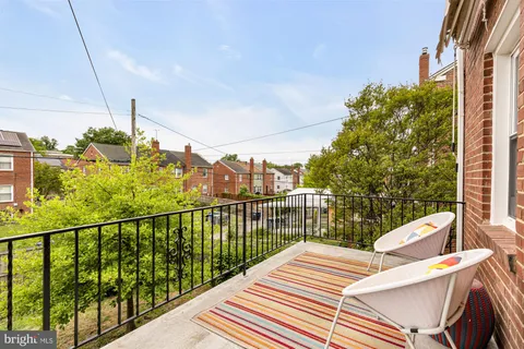 a view of a balcony with chairs