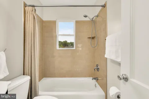 a bathroom with a bathtub and shower