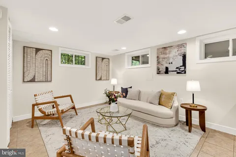 a living room with furniture and painting on the wall