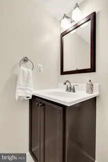 a bathroom with a sink vanity and mirror
