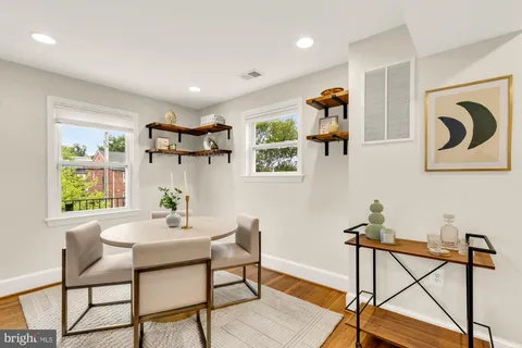 a view of a room with furniture and wooden floor