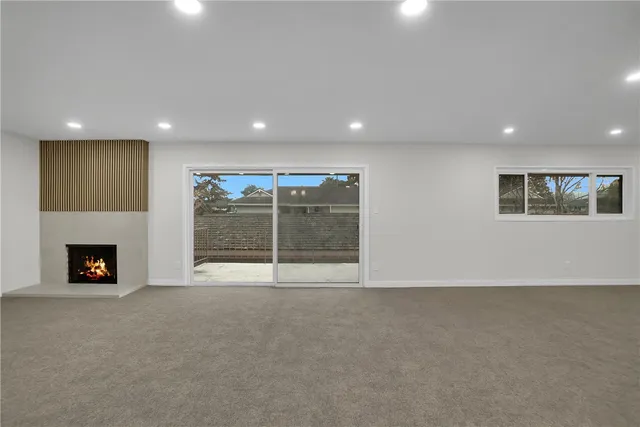 a view of an empty room with a fireplace