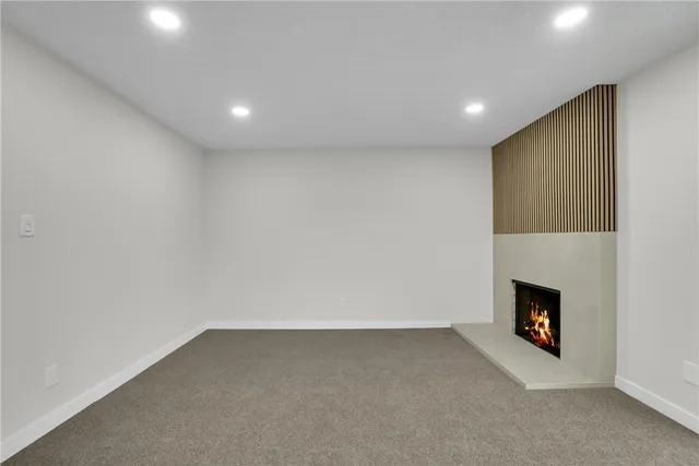 a view of an empty room with a fireplace