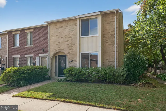 a brick building with a yard in front of it