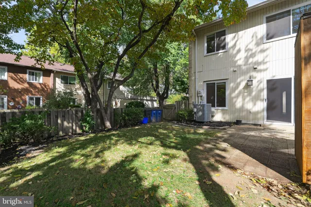a view of a house with backyard and tree
