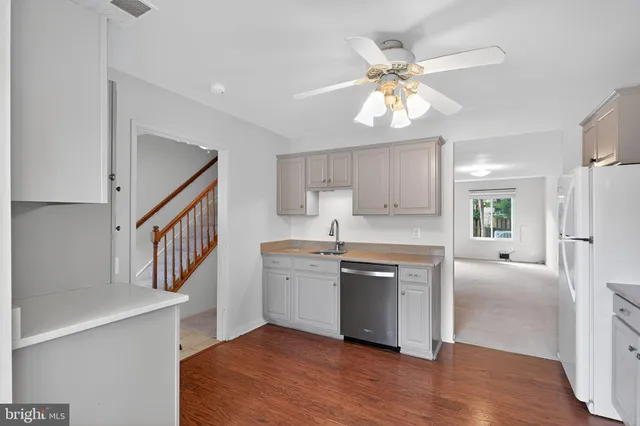 a kitchen with stainless steel appliances kitchen island a refrigerator sink and cabinets