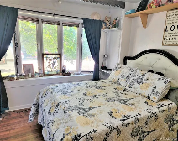 a bedroom with a bed and a large window