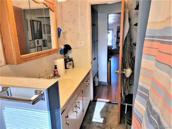 a view of a bathroom with a sink and mirror