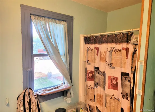 a view of a balcony with wooden floor and door