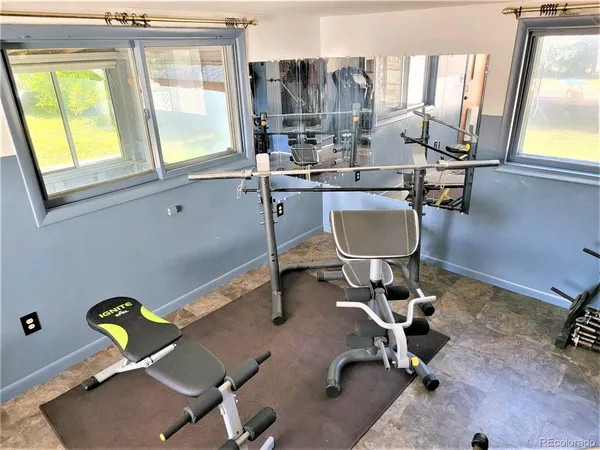 a room with table chairs and windows