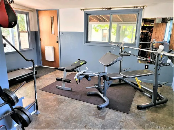 a room with gym equipment and a window