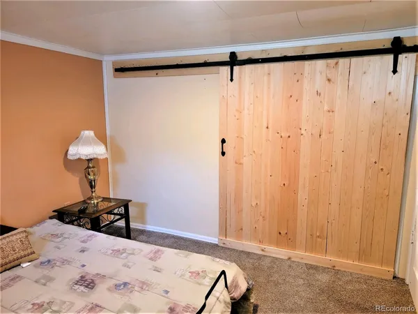 a bed room with a bed and a chair