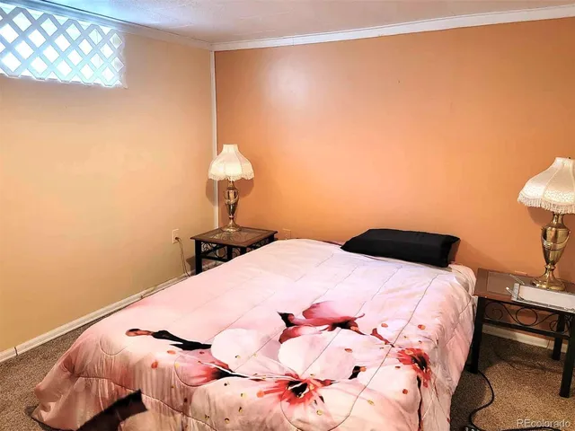 a bedroom with a bed and a night stand