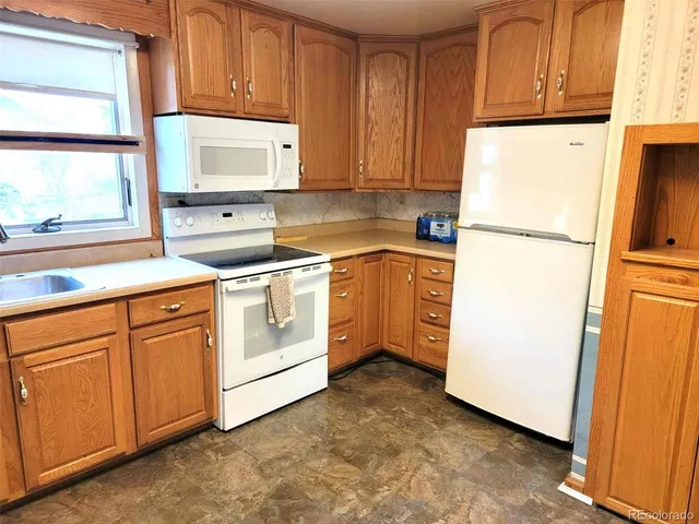 a kitchen with stainless steel appliances granite countertop a refrigerator sink and cabinets