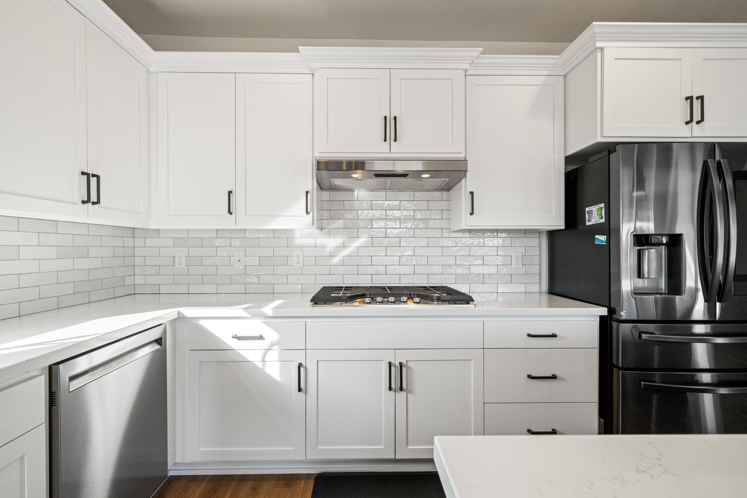3001 Luke Trail Redding, CA 96002 - Photo 12 of 43 a kitchen with white cabinets and stainless steel appliances