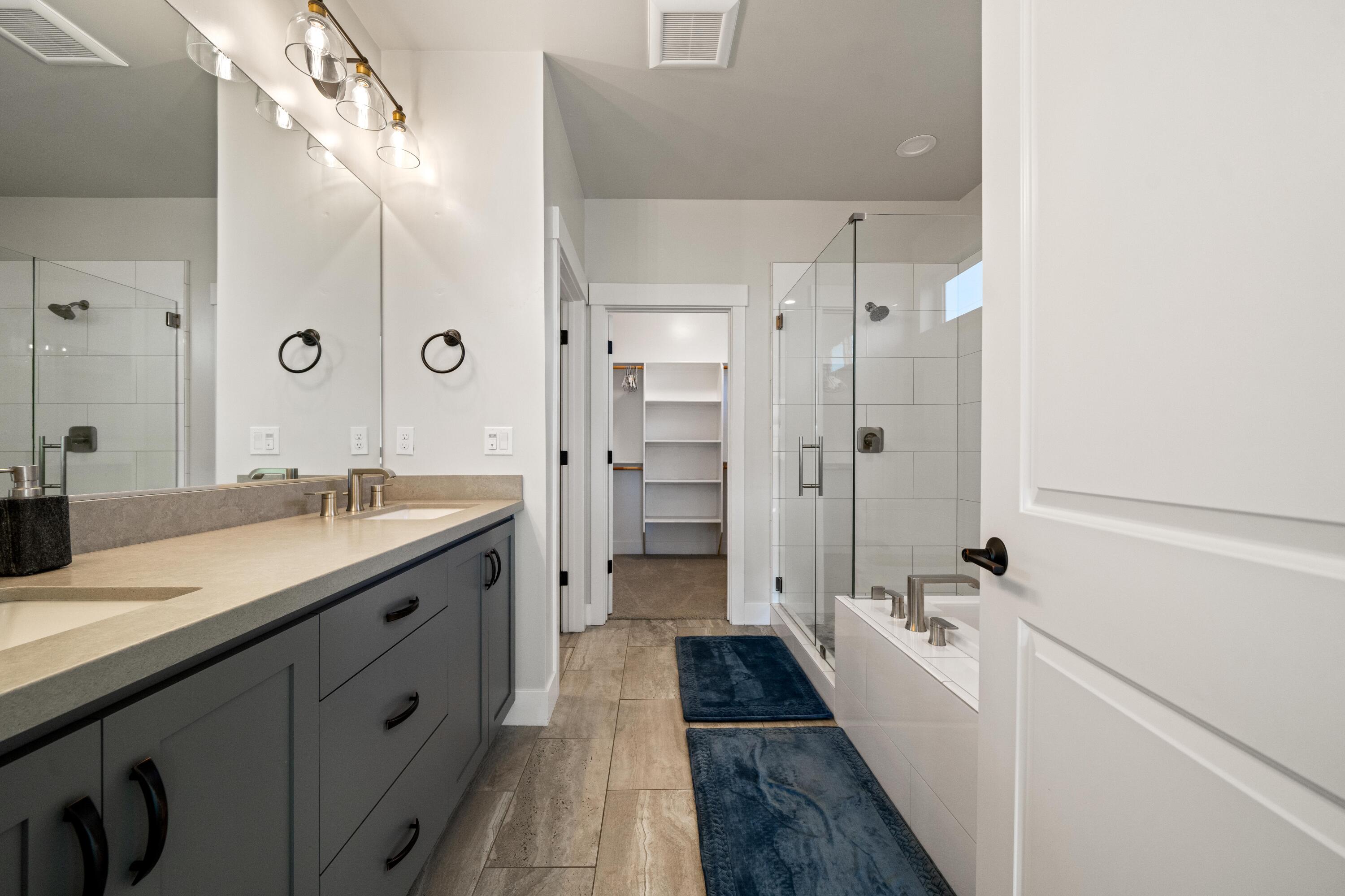 3001 Luke Trail Redding, CA 96002 - Photo 16 of 43 a spacious bathroom with a double vanity sink a large mirror and shower