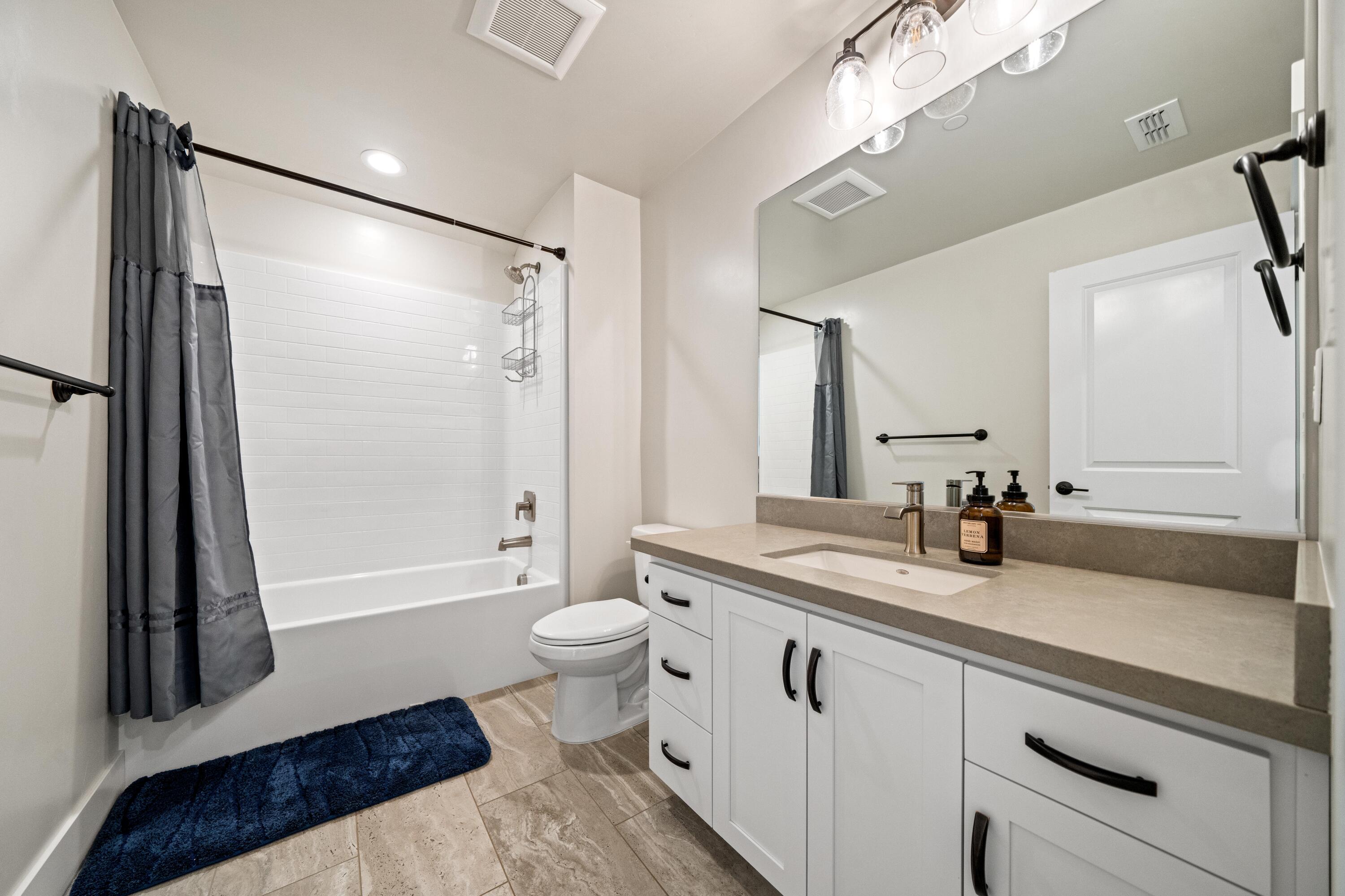 3001 Luke Trail Redding, CA 96002 - Photo 25 of 43 a bathroom with a double vanity sink toilet mirror and a bathtub