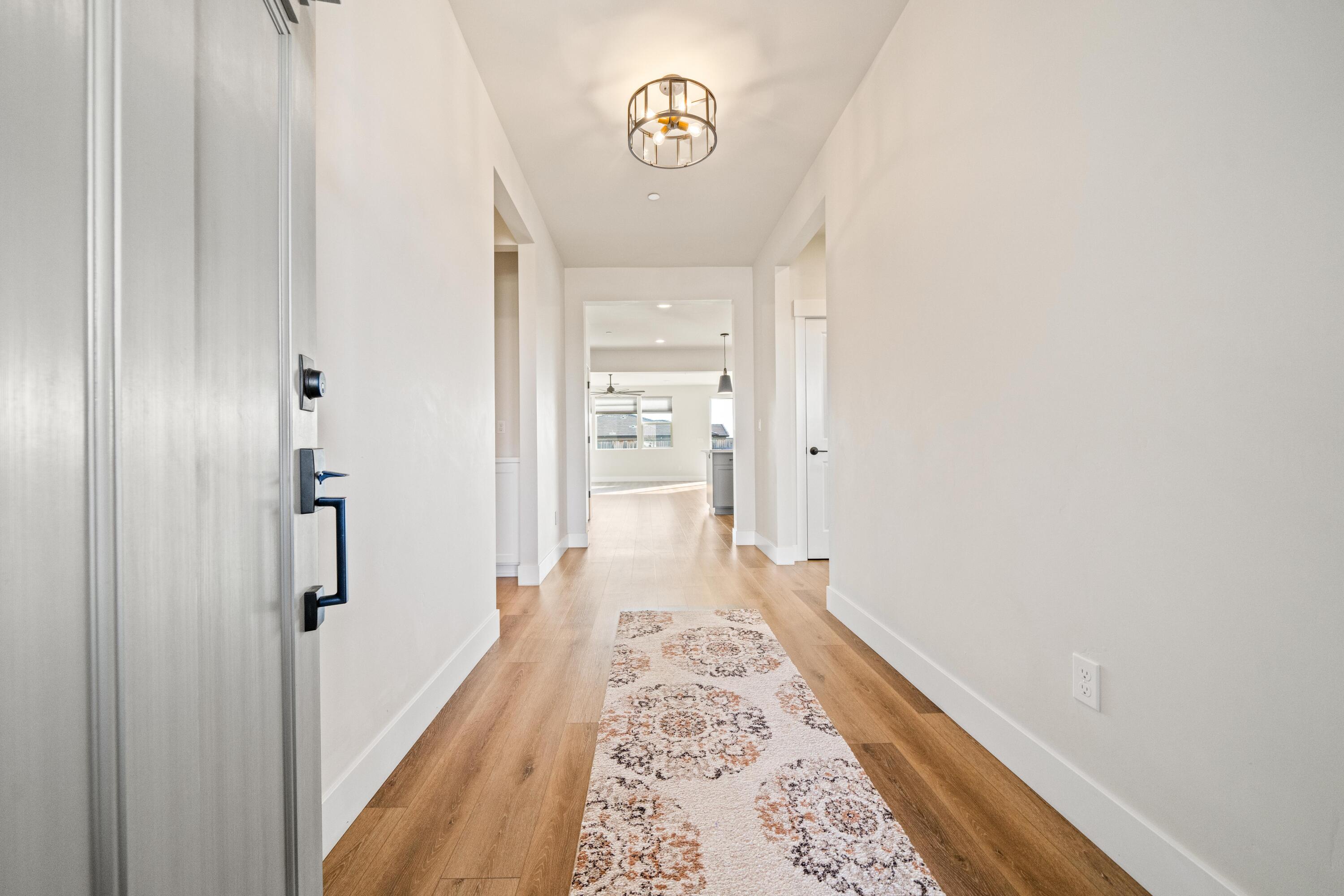 3001 Luke Trail Redding, CA 96002 - Photo 5 of 43 a view of a hallway with wooden floor and staircase