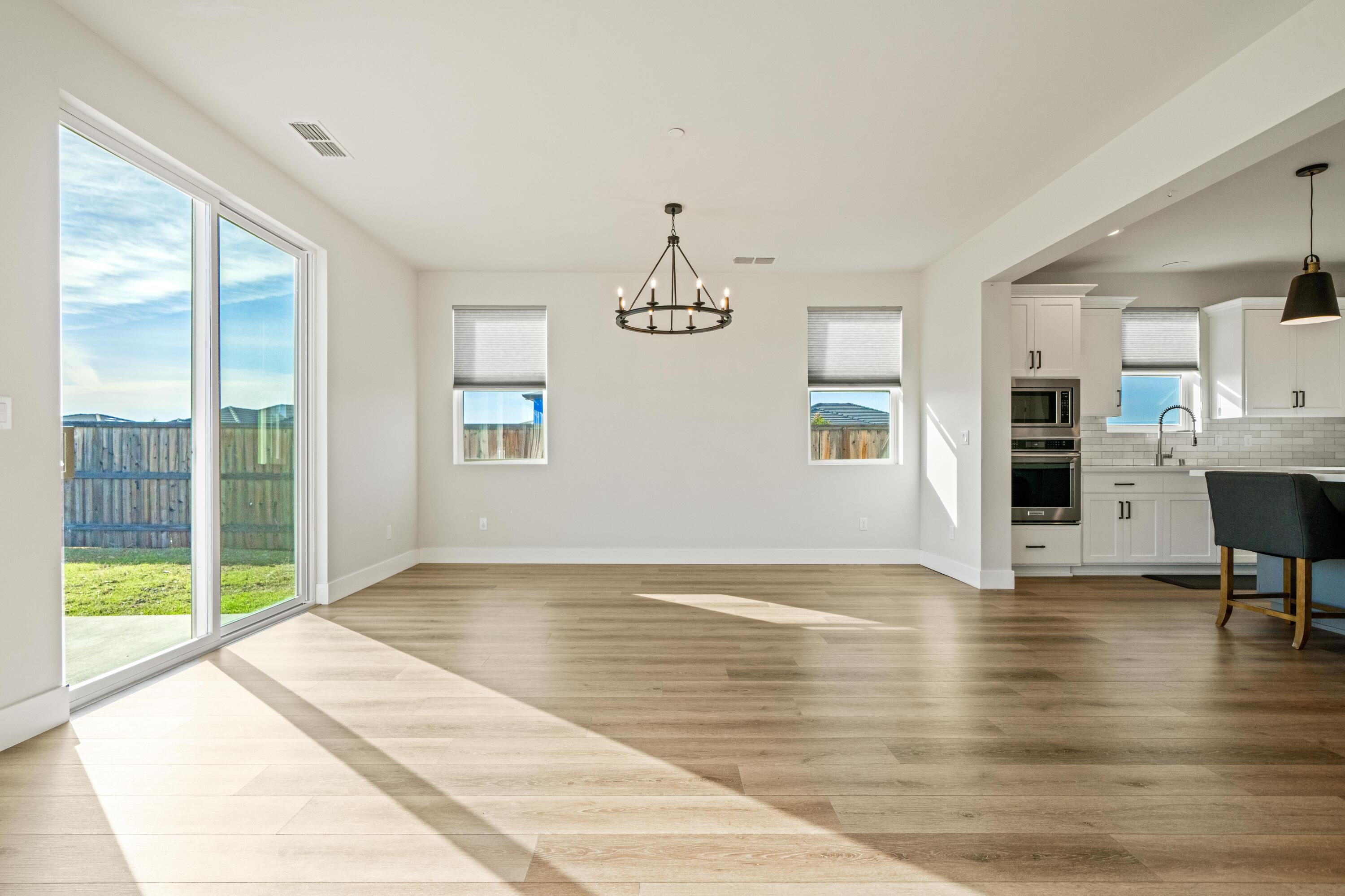 3001 Luke Trail Redding, CA 96002 - Photo 8 of 43 a view of an empty room with window and wooden floor