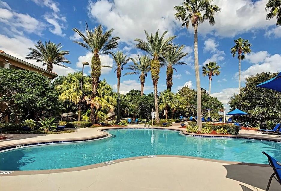 7320 Westpointe Boulevard, Unit 526 Orlando, FL 32835 - Photo 15 of 20 a view of a swimming pool with a garden
