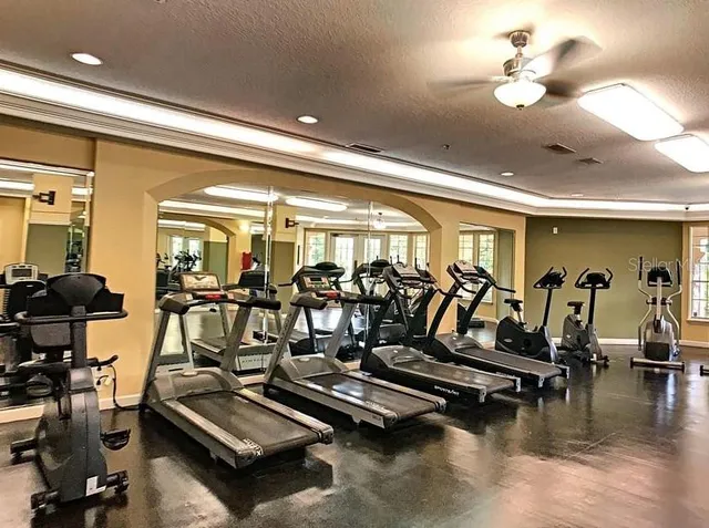 a view of a room with lots of gym equipment