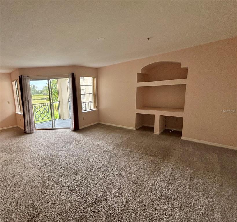 7320 Westpointe Boulevard, Unit 526 Orlando, FL 32835 - Photo 7 of 20 an empty room with windows and closet