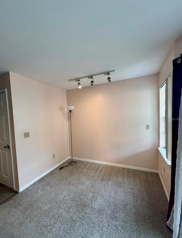 7320 Westpointe Boulevard, Unit 526 Orlando, FL 32835 - Photo 8 of 20 a view of a room with racks on the wall