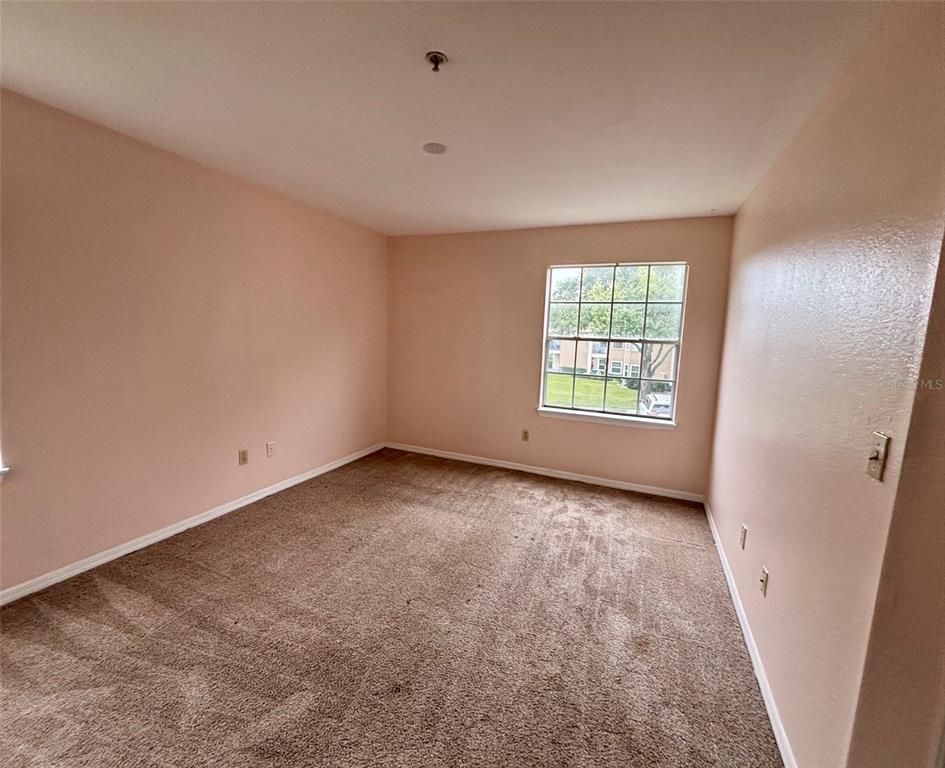 7320 Westpointe Boulevard, Unit 526 Orlando, FL 32835 - Photo 9 of 20 an empty room with windows