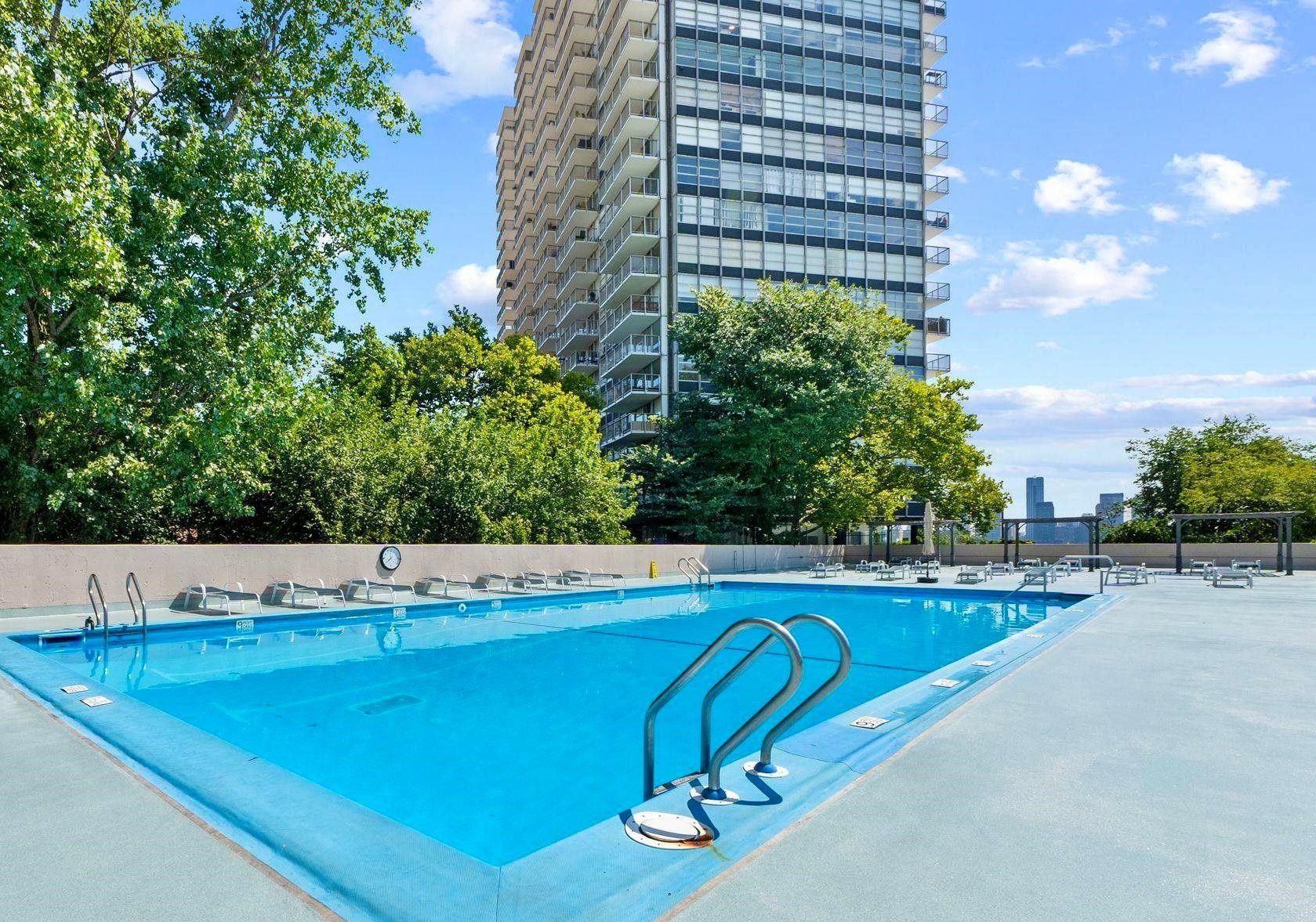 6040 Boulevard East, Unit 6B West New York, NJ 07093 - Photo 3 of 32 a view of a swimming pool with a yard