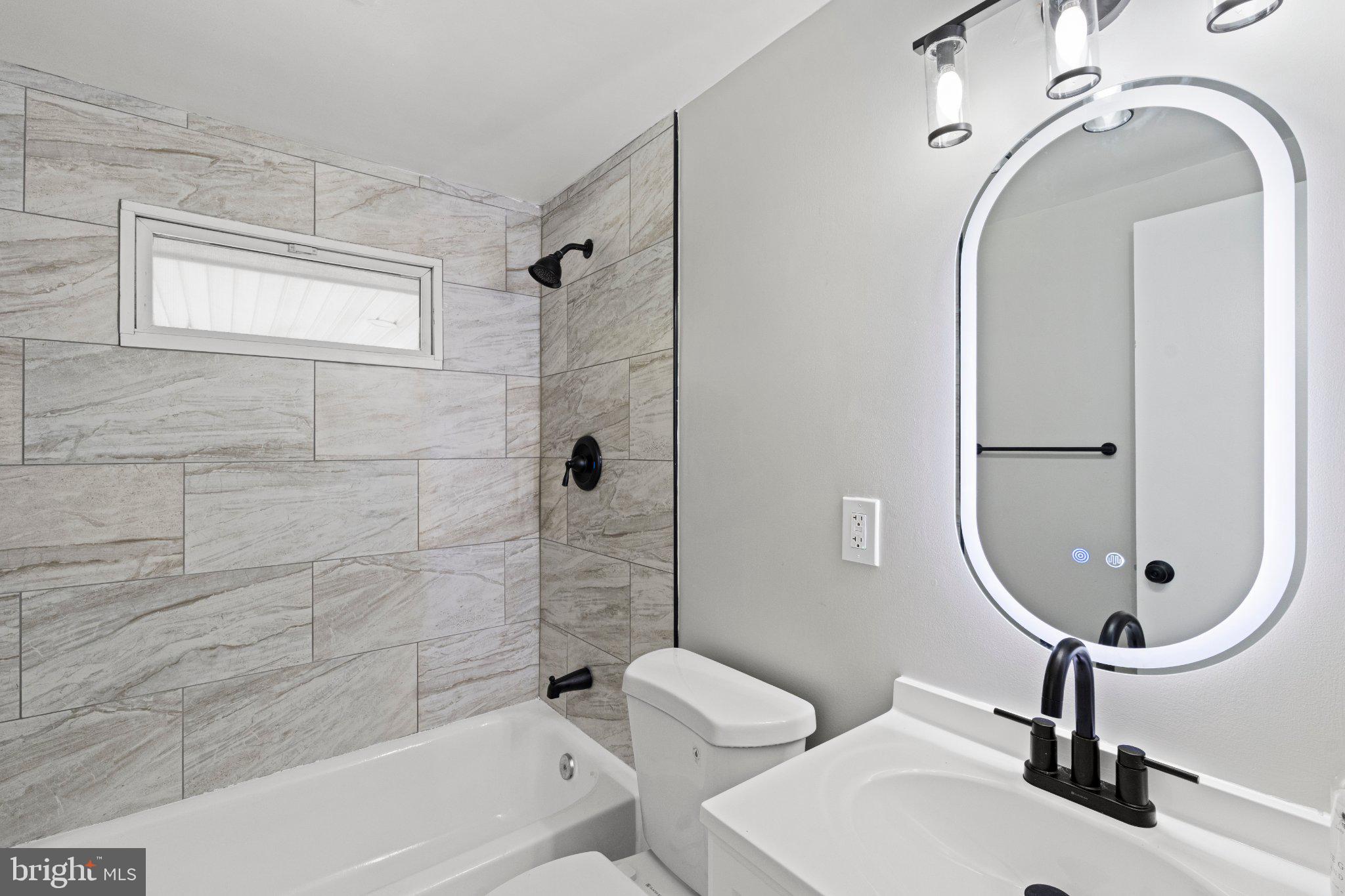 8405 Shirley Road Spotsylvania, VA 22551 - Photo 27 of 42 a bathroom with a sink a toilet and shower