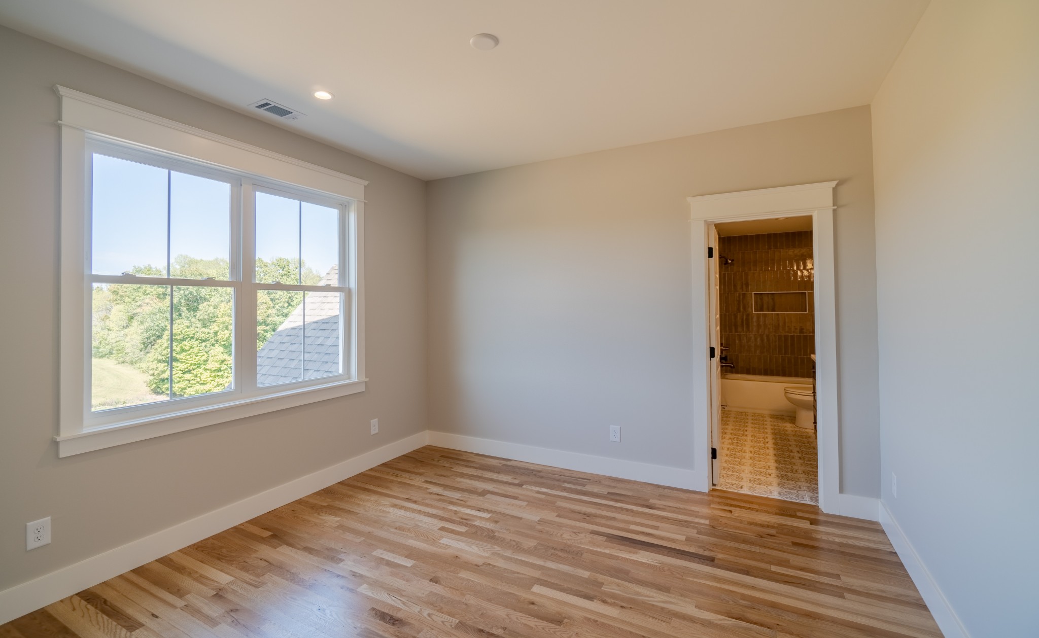 7039 Hall Road Greenbrier, TN 37073 - Photo 44 of 73 a view of an empty room with wooden floor and a window