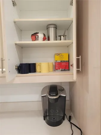 a kitchen with stainless steel appliances white cabinets and a refrigerator