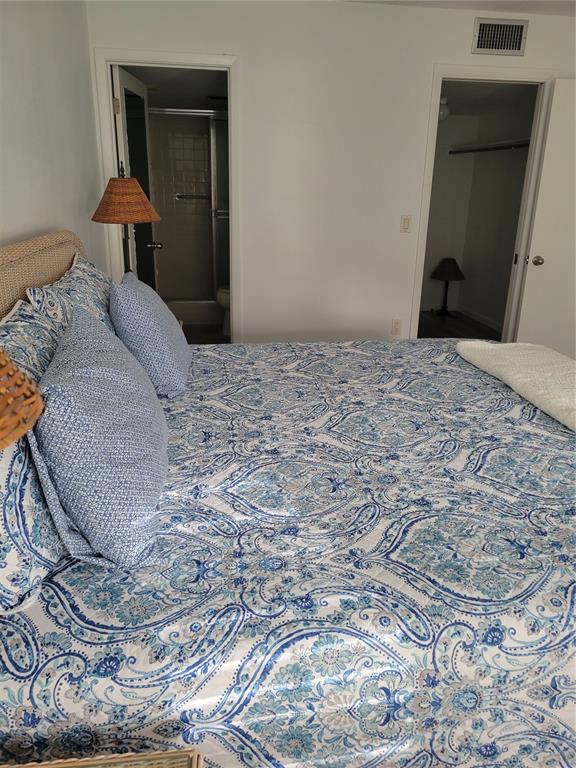 220 Santa Maria Street, Unit 442 Venice, FL 34285 - Photo 20 of 27 a bedroom with a bed and a mirror