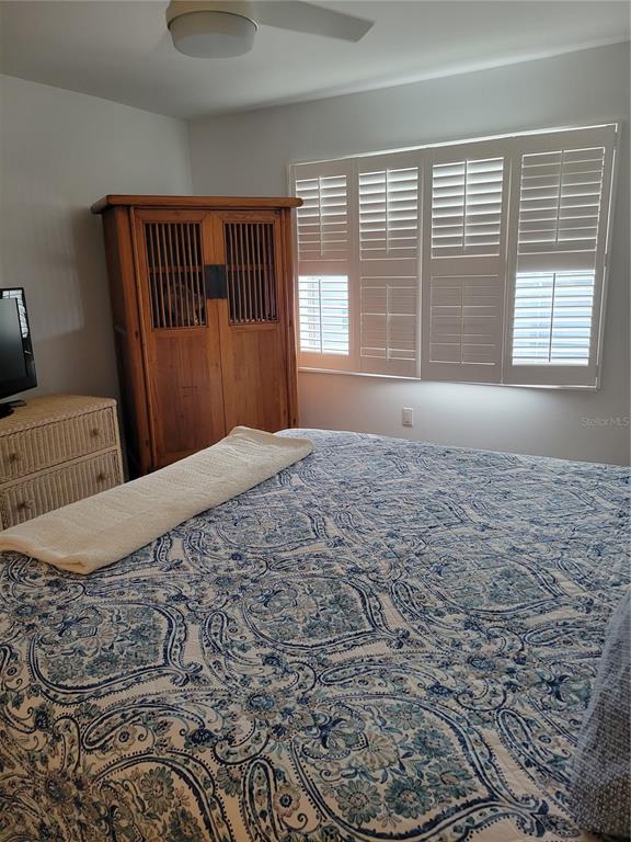 220 Santa Maria Street, Unit 442 Venice, FL 34285 - Photo 22 of 27 a large bed sitting in a bedroom next to a window