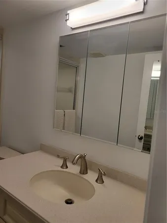 a bathroom with a toilet sink and shower curtain