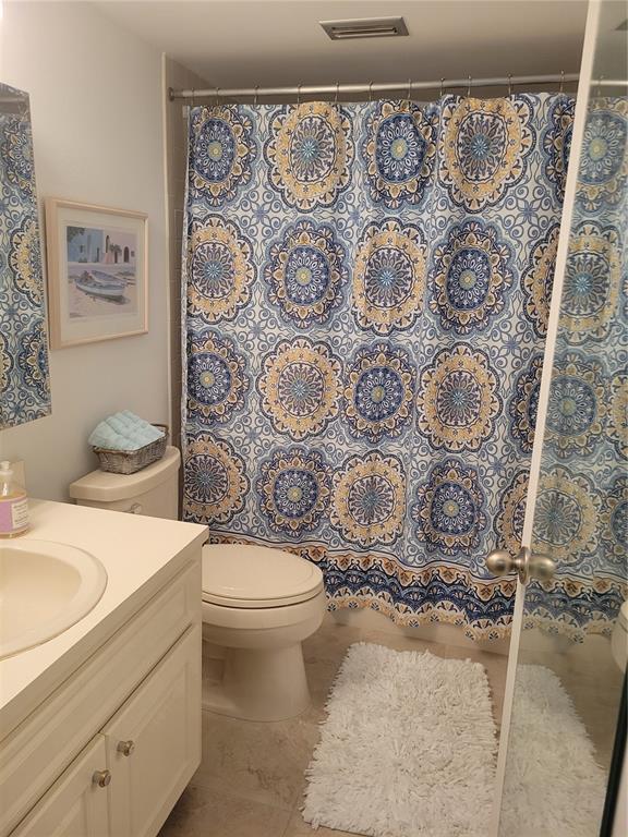 220 Santa Maria Street, Unit 442 Venice, FL 34285 - Photo 26 of 27 a bathroom with a toilet sink and shower curtain