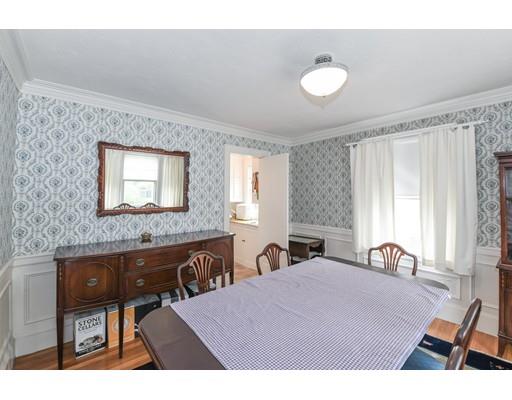 161 Lovell Road Watertown, MA 02472 - Photo 5 of 15 a bedroom with a bed and a table with mirror
