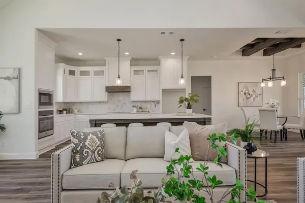 a living room with furniture and a chandelier