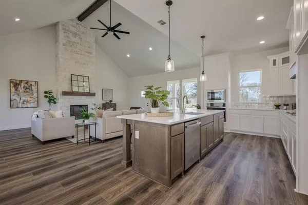 a kitchen with sink cabinets and wooden floor